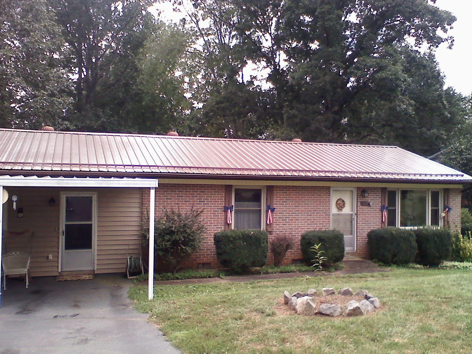 Bronze metal roof and carport on a brick ranch home — Roof Repair work by our crew in Castleton On Hudson